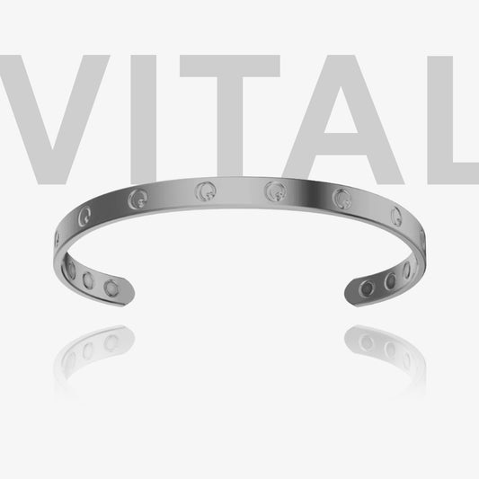 Silver bracelet with cut-out design on a white background with 'VITAL' text.